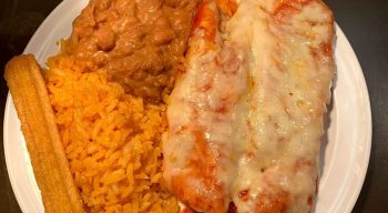 Home cooked red sauce Chicken Enchiladas, Mexican rice, home cooked beans and Mexican churro