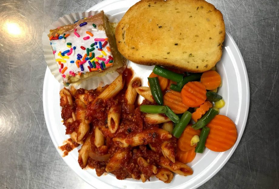 Penne Pasta Bolognese cooked in our own sauce recipe, Baked garlic bread, Seasonal veggies and yellow cake