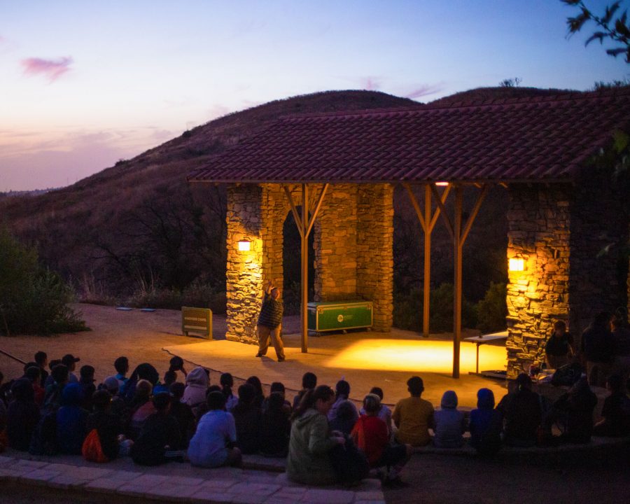 Outdoor amphitheater in the evening filled with camprers