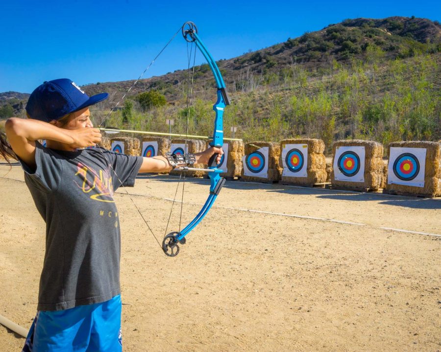 Boy shooting archery arrow at Irvine Ranch