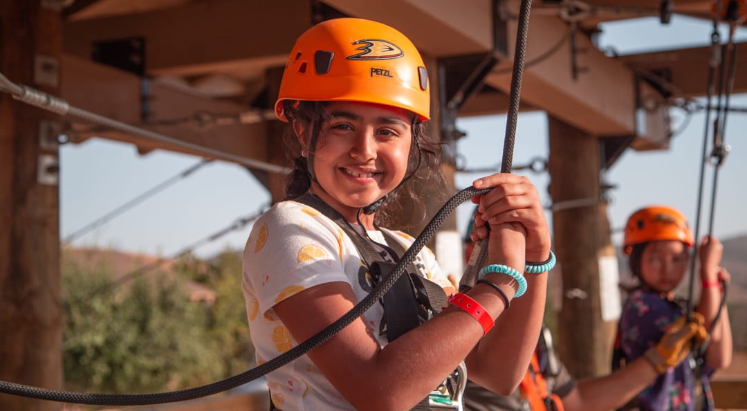 Girl ready to zip line at Adventure Hill