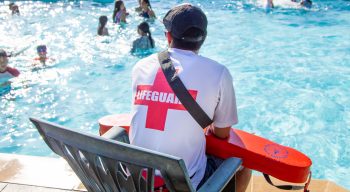 Lifeguard sitting by the pool