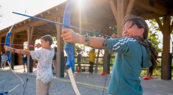 Kids shooting arrows at archery range