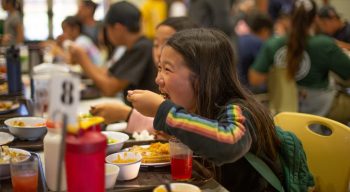 Girl eating lunch at dining hall at Irvine Ranch