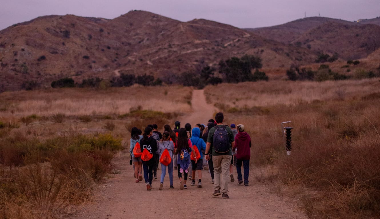 Teens on a night hike during an overnight program