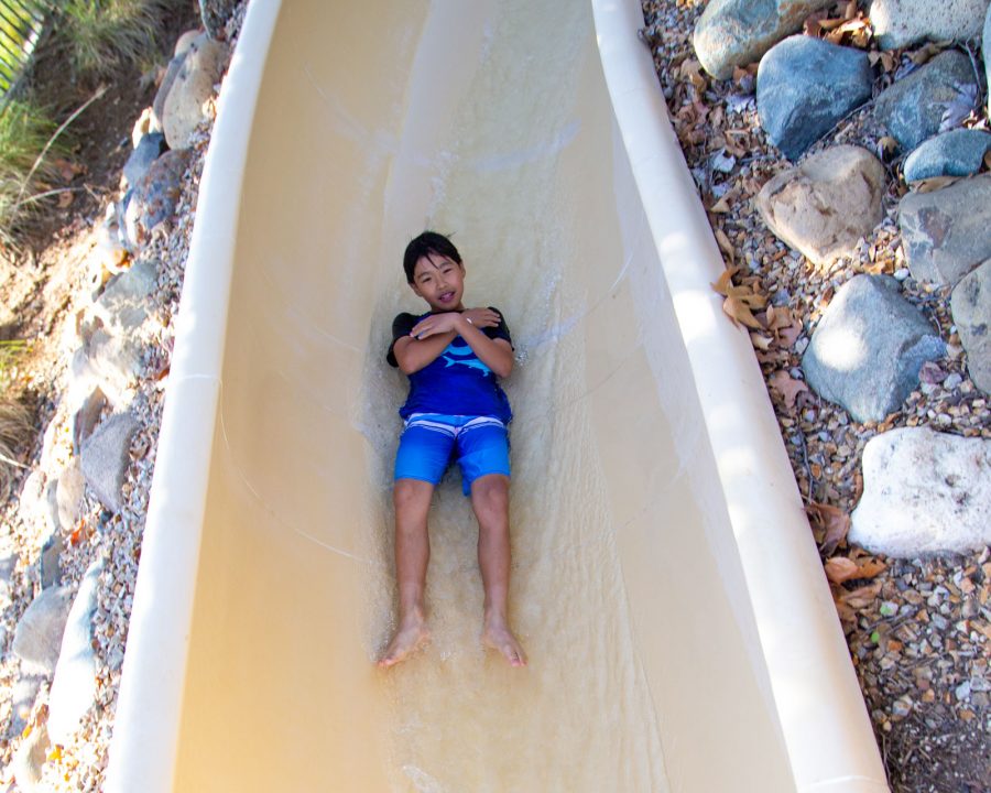 Boy going down water slide at the aquatic center