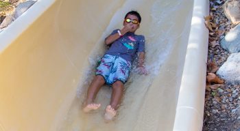 Boy going down the water slide at the Aquatic Center